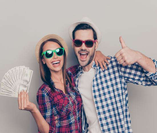 happy couple holding cash