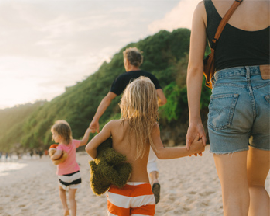 Family walking on a beach in Bali