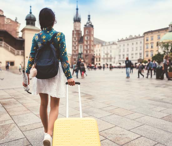 traveller with suitcase on a tourist square