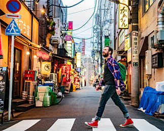 man walking in narrow and foreign street